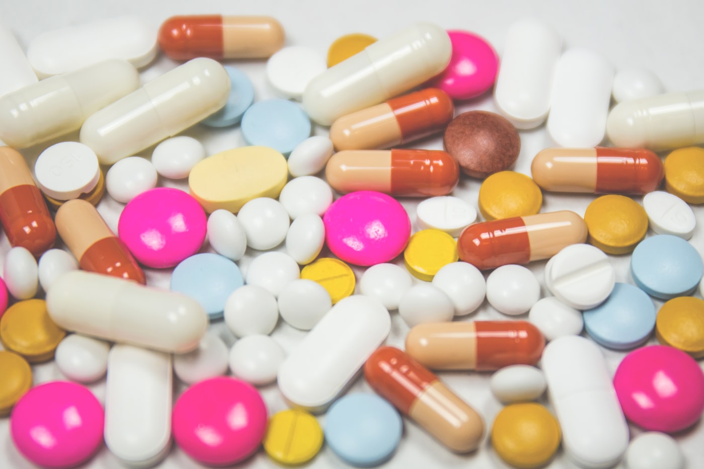 Assorted tablets and capsules, representing pill formulation questions.
